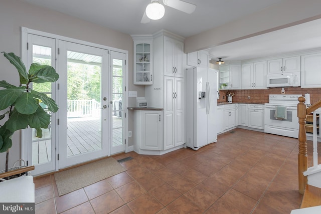 kitchen featuring visible vents, white appliances, glass insert cabinets, white cabinets, and a ceiling fan