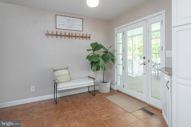 doorway with baseboards, tile patterned flooring, french doors, and visible vents