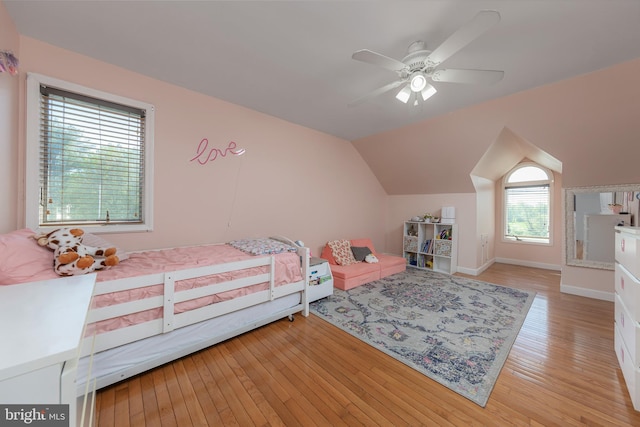 bedroom with vaulted ceiling, baseboards, a ceiling fan, and light wood finished floors
