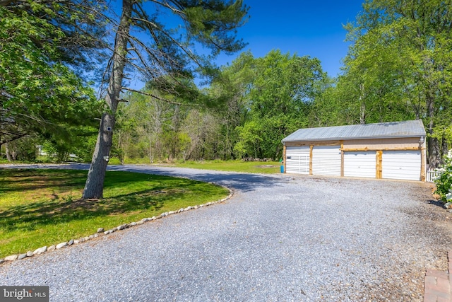 detached garage featuring gravel driveway