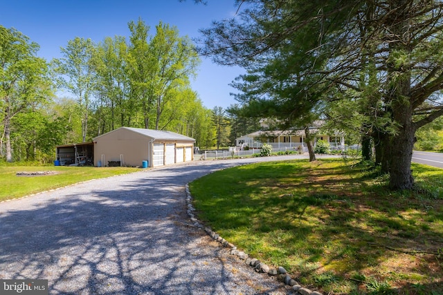 exterior space featuring a garage, an outbuilding, a pole building, and a front yard
