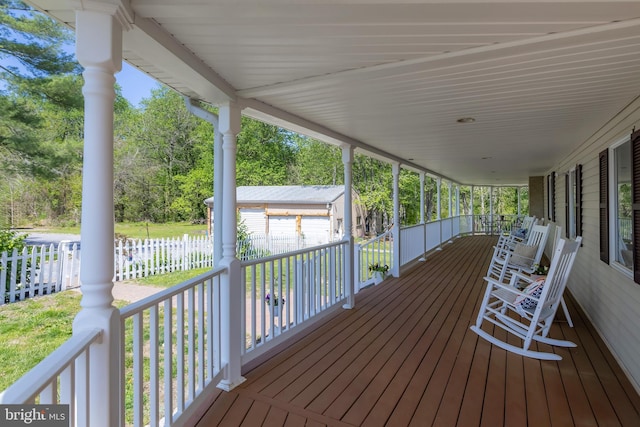 deck featuring covered porch and an outdoor structure