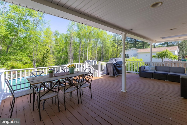 deck featuring outdoor dining area, area for grilling, and outdoor lounge area
