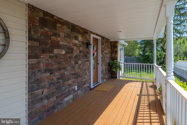 wooden terrace with fence and covered porch