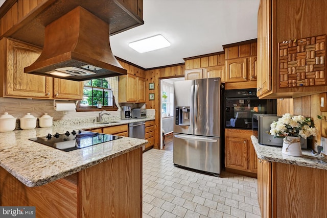 122 Tregarone Rd, Lutherville Timonium, MD 21093 - kitchen with wooden walls, a sink, a peninsula, island range hood, and black appliances