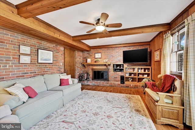 122 Tregarone Rd, Lutherville Timonium, MD 21093 - living room with a ceiling fan, brick wall, a fireplace, beam ceiling, and wood finished floors