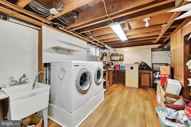 122 Tregarone Rd, Lutherville Timonium, MD 21093 - clothes washing area with a sink, laundry area, light wood finished floors, and washer and clothes dryer