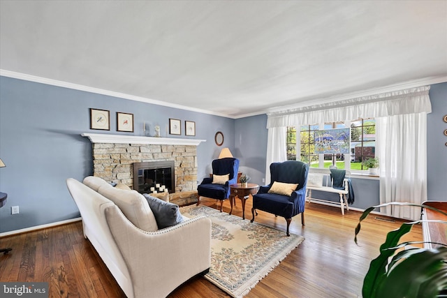 122 Tregarone Rd, Lutherville Timonium, MD 21093 - living room featuring crown molding, baseboards, a stone fireplace, and wood finished floors