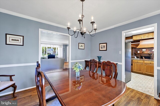 122 Tregarone Rd, Lutherville Timonium, MD 21093 - dining room featuring baseboards, ornamental molding, wood finished floors, and a chandelier