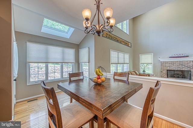 dining area featuring light wood-style floors, baseboards, a chandelier, and visible vents