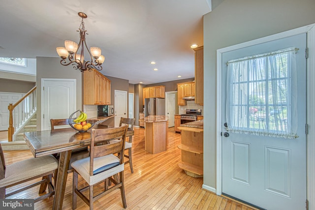 dining area with light wood-style floors, recessed lighting, a chandelier, and stairway