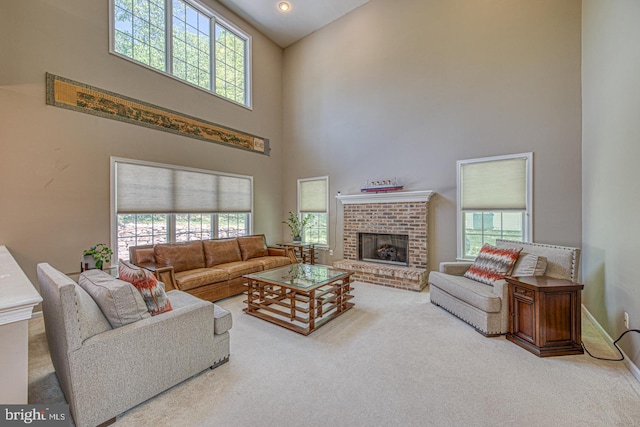 living room featuring carpet floors, a high ceiling, and a wealth of natural light