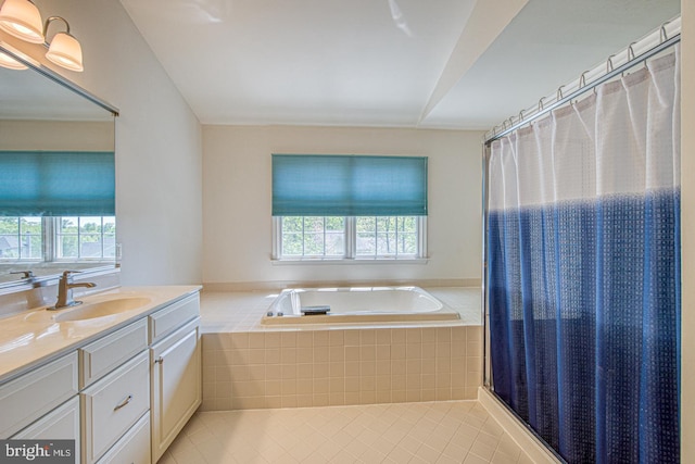 full bathroom with vanity, tile patterned floors, a bath, and a healthy amount of sunlight