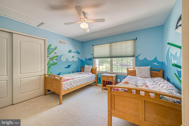 bedroom with a closet, a ceiling fan, carpet flooring, and visible vents
