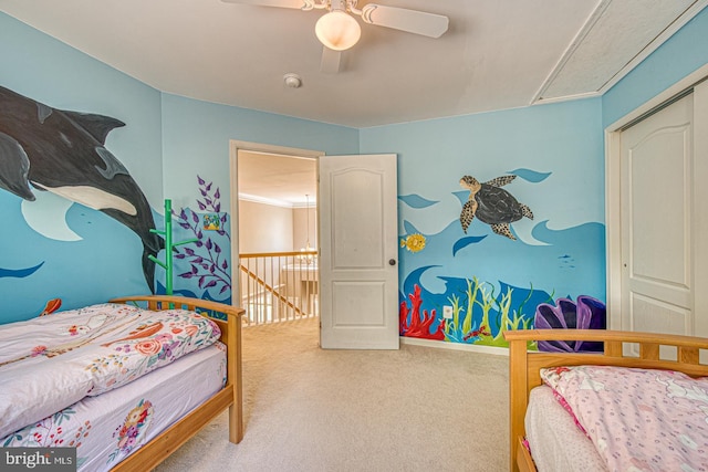 carpeted bedroom featuring ceiling fan, baseboards, and attic access