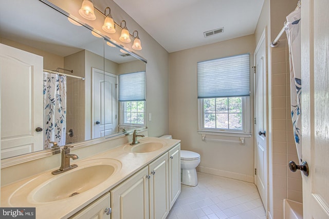 bathroom with a sink, tile patterned floors, toilet, and visible vents