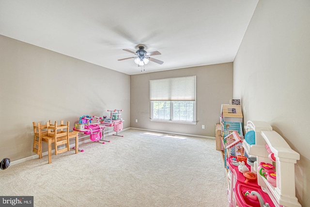 game room with carpet floors, baseboards, and a ceiling fan