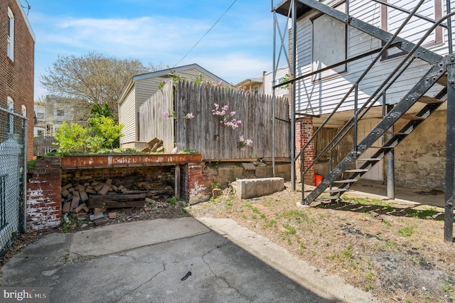 exterior space featuring fence and stairs