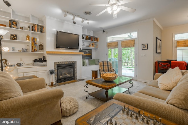 7645 E Longfield Dr, Hebron, MD 21830 - living area with plenty of natural light, ornamental molding, a ceiling fan, and a tile fireplace