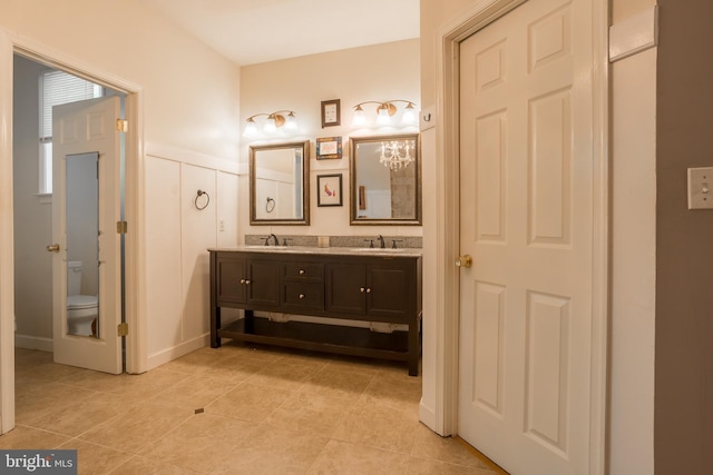 7645 E Longfield Dr, Hebron, MD 21830 - full bathroom featuring a sink, tile patterned flooring, toilet, and double vanity