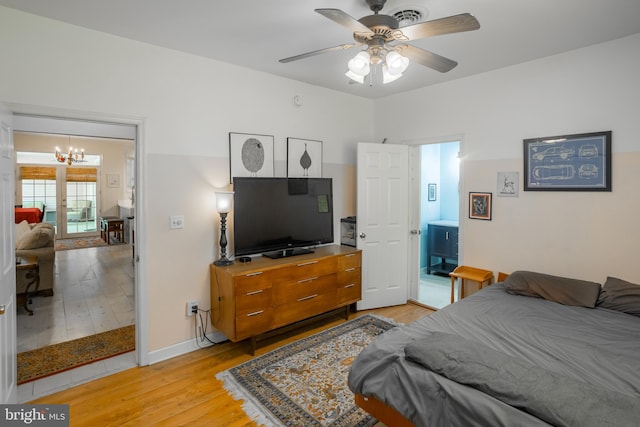 7645 E Longfield Dr, Hebron, MD 21830 - bedroom featuring baseboards, ceiling fan with notable chandelier, light wood-style flooring, and visible vents