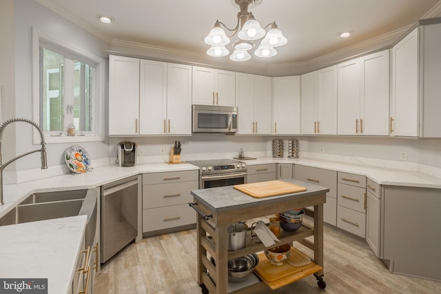 7645 E Longfield Dr, Hebron, MD 21830 - kitchen featuring ornamental molding, gray cabinets, a sink, a notable chandelier, and stainless steel appliances