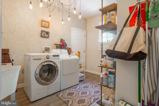 7645 E Longfield Dr, Hebron, MD 21830 - laundry area featuring washing machine and clothes dryer, laundry area, a sink, baseboards, and wood finished floors