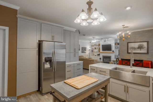 7645 E Longfield Dr, Hebron, MD 21830 - kitchen with gray cabinetry, a sink, a glass covered fireplace, open floor plan, and stainless steel fridge