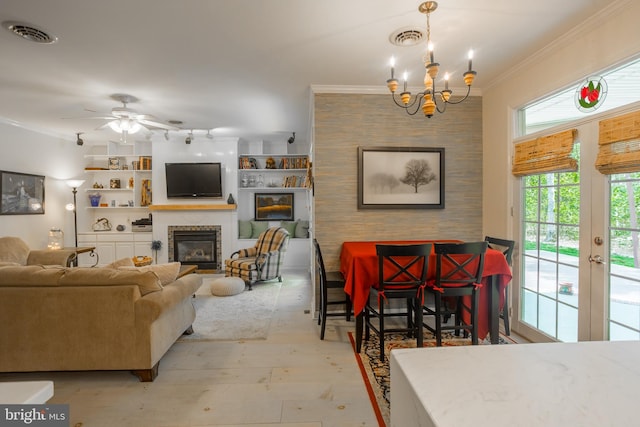7645 E Longfield Dr, Hebron, MD 21830 - dining space featuring visible vents, a glass covered fireplace, ornamental molding, and ceiling fan with notable chandelier
