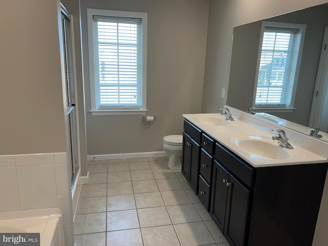 full bath with tile patterned floors, plenty of natural light, and a sink