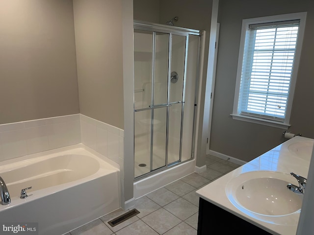 full bath featuring a sink, tile patterned floors, a shower stall, and visible vents