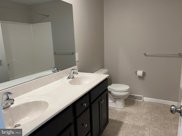 bathroom featuring visible vents, a sink, baseboards, and toilet