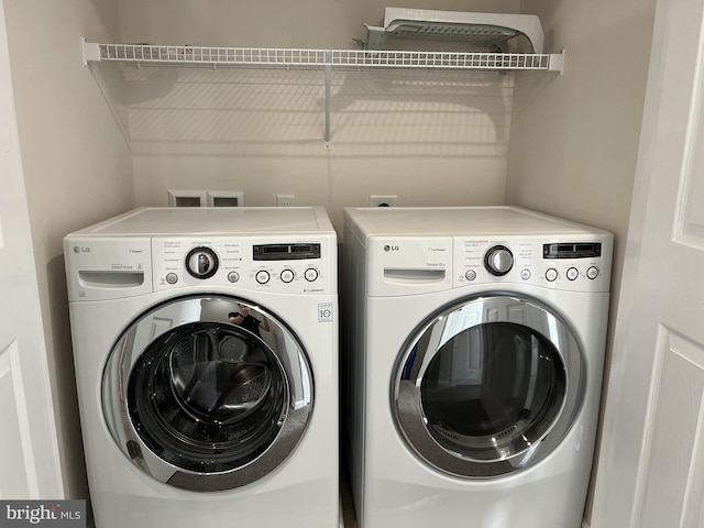 laundry area with separate washer and dryer and laundry area