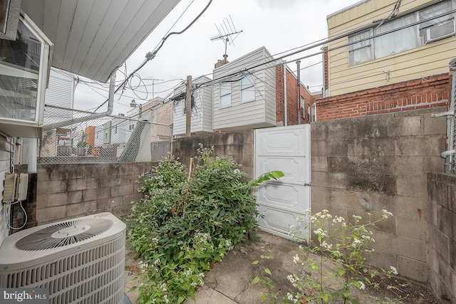 exterior space with central air condition unit and fence