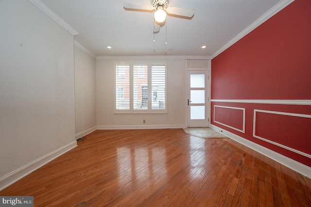 spare room with ornamental molding, wood finished floors, baseboards, ceiling fan, and recessed lighting