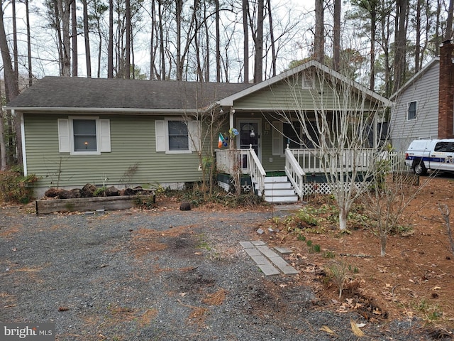 view of front of house with a shingled roof and a porch