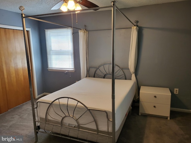carpeted bedroom featuring a ceiling fan and a textured ceiling