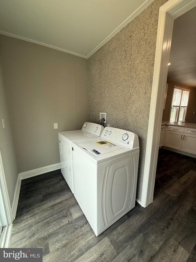 laundry area featuring baseboards, ornamental molding, dark wood-style floors, and washing machine and clothes dryer