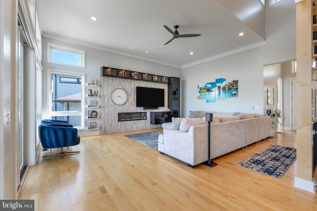 living room featuring crown molding, a ceiling fan, recessed lighting, and wood finished floors