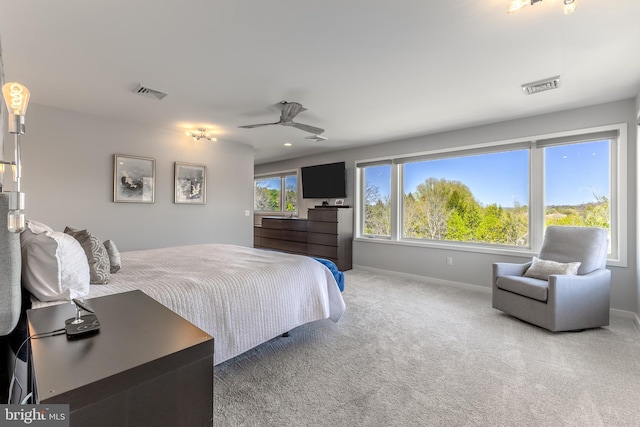 carpeted bedroom featuring a ceiling fan, baseboards, and visible vents