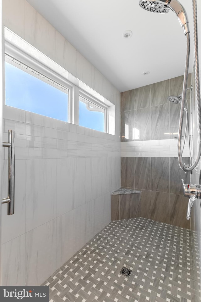 bathroom with tiled shower