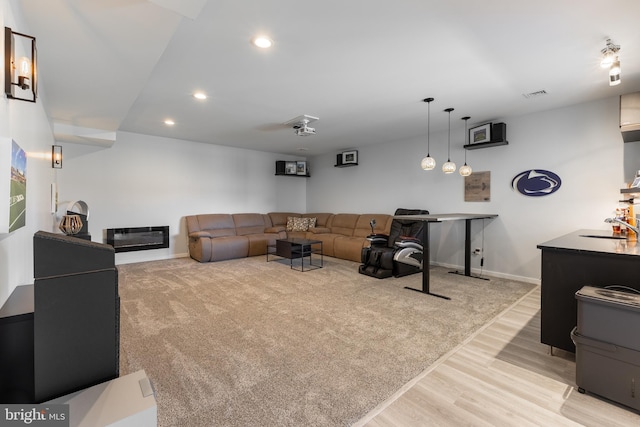 living area with recessed lighting, light wood-style floors, baseboards, and visible vents