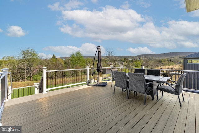 deck featuring a mountain view and outdoor dining space