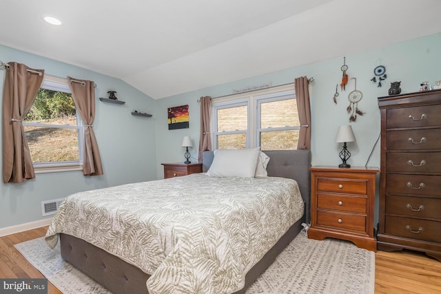 bedroom featuring visible vents, baseboards, lofted ceiling, recessed lighting, and light wood-style flooring
