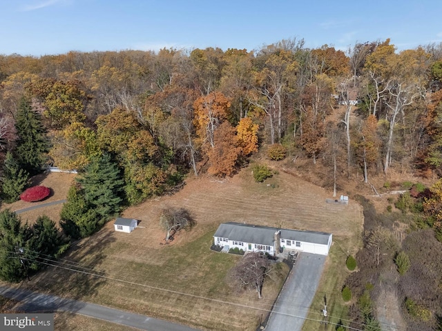 bird's eye view with a wooded view