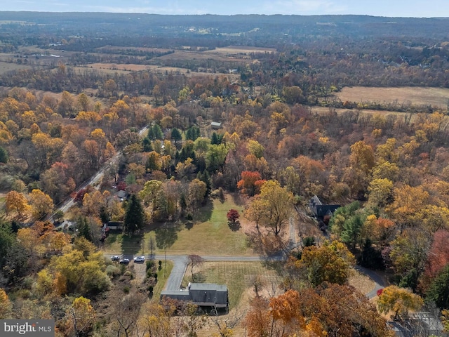 drone / aerial view featuring a wooded view