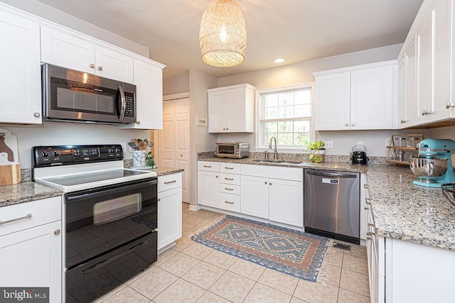 kitchen featuring white cabinets, appliances with stainless steel finishes, a sink, light tile patterned floors, and a toaster