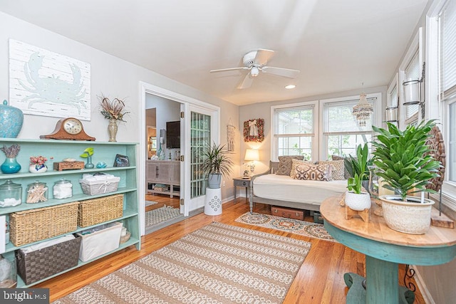 living area with baseboards, ceiling fan, recessed lighting, and wood finished floors
