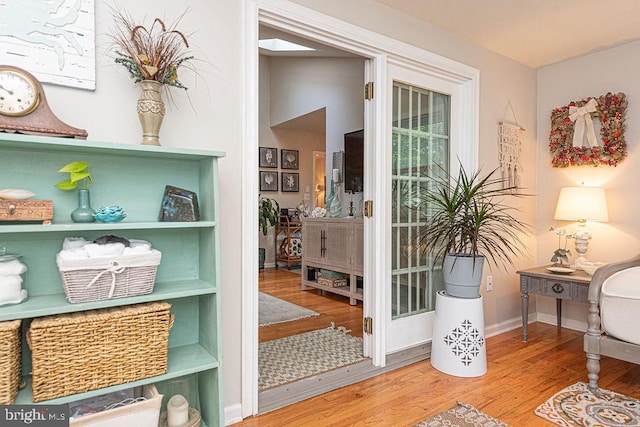 doorway to outside with baseboards and wood finished floors