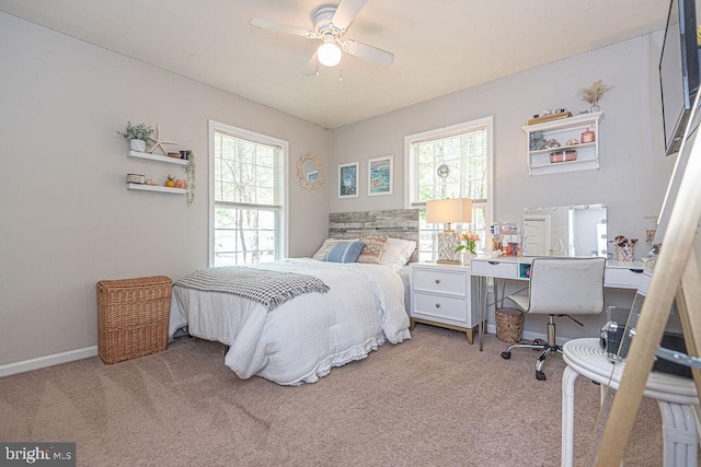 bedroom featuring baseboards and light carpet